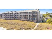 Beachfront condo building with multiple levels of screened in porches, close beach access, and beautiful landscaping at 208 Ocean Blvd. N # 228, North Myrtle Beach, SC 29582