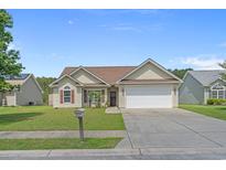 Charming single-story home featuring a well-manicured lawn and a two-car garage at 227 Hickory Springs Ct., Conway, SC 29527