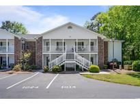 Inviting condo with brick accents, white stairs, and balconies at 245 Egret Run Ln. # 1023, Pawleys Island, SC 29585
