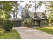Charming two-story home with dormer windows, a spacious driveway, and attached garage at 302 St. Andrews Ln., Myrtle Beach, SC 29588