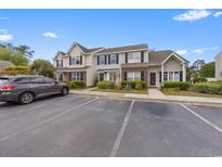 Townhome exterior showing parking, landscaping, and classic design with brick accents at 3563 Chestnut Dr. # 3563, Myrtle Beach, SC 29577