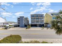 Beach homes with multi-level balconies and covered parking offer coastal living near the ocean and local roads at 4201 N Ocean Blvd. # 2H, North Myrtle Beach, SC 29582