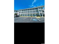 Exterior of home showing multiple units, blue skies and handicap parking spot at 4669 Wild Iris Dr. # 22-2O2, Myrtle Beach, SC 29577