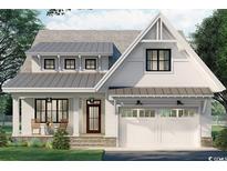 Charming two-story home featuring a metal roof, inviting front porch, and an attached two-car garage at 573 Starlit Way, Myrtle Beach, SC 29579