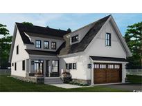New construction home featuring a stylish exterior with a two-car garage and covered front porch at 573 Starlit Way, Myrtle Beach, SC 29579