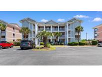 A bright, multi-story condo building with classic white pillars and lush palms in a well-maintained community at 608 Waterway Village Blvd. # 27-F, Myrtle Beach, SC 29579