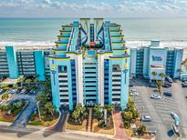 Brightly colored exterior of beachfront condo with pool, parking, and ocean views at 6804 N Ocean Blvd. # 523, Myrtle Beach, SC 29572