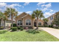 Charming single-story home with well-manicured lawn, vibrant landscaping, and mature palm trees at 7041 Turtle Cove Dr., Myrtle Beach, SC 29579