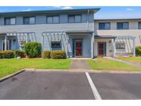 Charming townhome featuring well-maintained landscaping and a welcoming entrance at 775 Plantation Dr. # 87, Little River, SC 29566