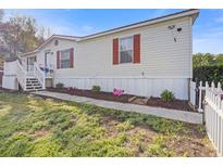 Charming single-story home featuring white siding, a red roof, and a landscaped front yard at 8404 Bloomwood Dr., Myrtle Beach, SC 29588