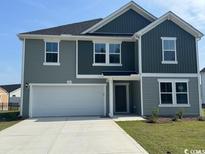 Charming two-story home with a two-car garage, manicured lawn, and classic curb appeal at 978 Cherrystone Loop, Conway, SC 29526