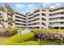 Beautifully landscaped condo complex with mature plants and views from multiple levels at 1301 N Waccamaw Dr. # 211, Garden City Beach, SC 29576