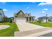 Charming two-story home featuring a two-car garage and a well-manicured front yard in a desirable neighborhood at 5000 Azul Loop, Myrtle Beach, SC 29579