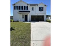 A charming two-story white home with black shutters, inviting front door, and an attached garage at 1028 Kinness Dr., Conway, SC 29527