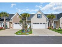 Charming townhome featuring a one-car garage, tidy landscaping, and a cozy front porch at 224 Je Edward Dr. # 17, Myrtle Beach, SC 29588