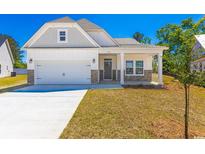 Charming single-story home with a well-manicured lawn, attached garage, and a welcoming front porch at 476 Honeyhill Loop, Conway, SC 29526