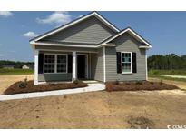 Charming single-story home featuring gray siding, a covered entryway, and well-manicured landscaping at 8050 Mill Pond Rd., Galivants Ferry, SC 29544