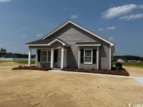 Charming single-story home with gray siding and a well-manicured front yard at 8054 Mill Pond Rd., Galivants Ferry, SC 29544