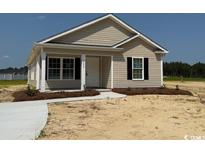 Charming single-story home with a light-colored exterior and a well-manicured lawn at 8058 Mill Pond Rd., Galivants Ferry, SC 29544