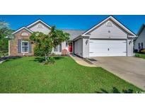 Charming single-story home with a brick accent, manicured lawn, and an attached two-car garage at 1154 Lampwick Ln., Murrells Inlet, SC 29576