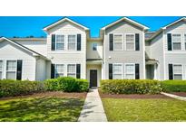 Inviting two-story townhome featuring a well-maintained lawn and charming black shutters at 121 Olde Towne Way # 2, Myrtle Beach, SC 29588