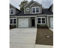Charming townhome featuring an attached garage and neutral-toned siding for a modern aesthetic at 1219 American Shad Dr. # 40, Conway, SC 29526