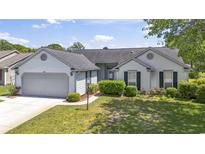 Charming single-story home features a well-maintained lawn and attached two-car garage at 1406 Snowy Egret Dr., Murrells Inlet, SC 29576