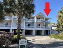 Charming condo building featuring multiple levels and balconies offering an inviting coastal aesthetic at 1516 Edge Dr. # 101, North Myrtle Beach, SC 29582