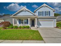 Charming two-story home with a cozy porch, landscaped lawn, and attached two-car garage at 1581 Culbertson Ave., Myrtle Beach, SC 29577