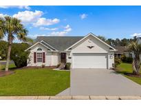 Charming single-story home with a well-maintained lawn and attached two-car garage at 2001 Neath Ct., Myrtle Beach, SC 29588