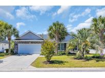 Charming single-story home with a well-manicured lawn and inviting curb appeal, complete with palm trees at 218 Old Hickory Dr., Conway, SC 29526
