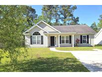 Charming single-story home with manicured lawn, black shutters and inviting front porch at 2429 Westbrook Dr., Conway, SC 29527