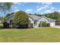 Charming single-story home with a well-manicured lawn, lush landscaping, and inviting curb appeal at 2654 Wild Game Trail, Myrtle Beach, SC 29588