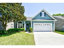 Charming home featuring a manicured lawn, two car garage and mature landscaping at 2705 South Key Largo Circle, Myrtle Beach, SC 29577