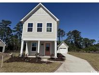 Charming two-story home with a peach-colored front door and a detached one-car garage at 2729 Rowyn St., Longs, SC 29568
