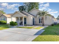 Charming single-story home featuring a well-manicured lawn, covered porch, and ample parking space in the driveway at 3012 Sabal Ct., Murrells Inlet, SC 29576
