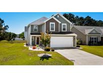 Charming two-story home with a two-car garage and manicured lawn in a suburban neighborhood at 356 Whipple Run Loop, Myrtle Beach, SC 29588