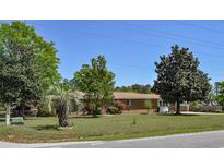 Charming brick home featuring a lush, well-manicured front yard with mature trees and landscaping at 4196 E Highway 319, Conway, SC 29526