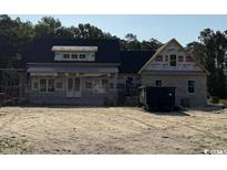 Charming new home features stone exterior, dormer windows, and a modern roofline at 4268 Long Avenue Ext., Conway, SC 29526