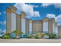 Stunning exterior view of a modern multi-story condo building with a manicured landscape at 4800 S Ocean Blvd. # 708, North Myrtle Beach, SC 29582