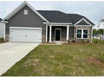 Charming single-Gathering home featuring stone accents, a two-car garage, and a well-manicured lawn at 484 Honeyhill Loop, Conway, SC 29526