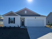 Charming single-Gathering home featuring a one car garage and well manicured lawn at 504 Blissful Ln., Little River, SC 29566
