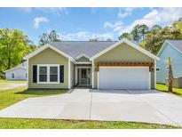 Charming single-story home with a welcoming front entrance and a two-car garage at 5132 Little River Neck Rd., North Myrtle Beach, SC 29582