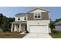 Charming two-story home features varied siding, attached garage, and a well-manicured front yard at 605 Muster Field Ct., Conway, SC 29526
