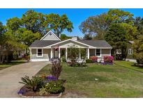 Charming single-story home with a well-manicured lawn, flower beds, and inviting front porch at 710 Yucca Ave., Myrtle Beach, SC 29577