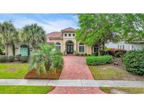 Stately home featuring lush landscaping, a circular driveway and a terracotta-tiled roof at 7470 Seville Dr., Myrtle Beach, SC 29572
