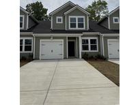 Charming townhome with a two-car garage and well-manicured landscaping at 1213 American Shad Dr. # 37, Conway, SC 29526