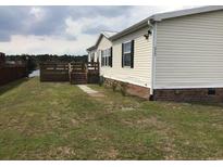 Charming home featuring vinyl siding, black shutters, and a lakeside deck at 212 Weyburn St., Myrtle Beach, SC 29579