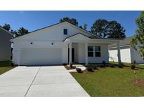 Charming, newly constructed two-story white home with a well-manicured lawn and attached garage at 1027 Laconic Dr., Myrtle Beach, SC 29588