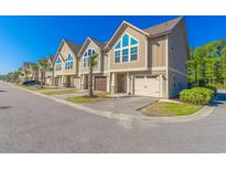 Charming townhomes showcase unique architectural details and well-manicured landscaping at 105 Villa Mar Dr. # C-1, Myrtle Beach, SC 29579